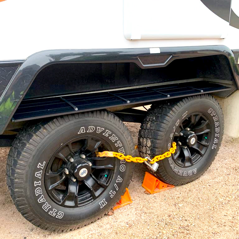 Foldable Caravan Outdoor Shelf unfolded and installed over a dual-axle wheel arch, providing organised storage for camping gear.