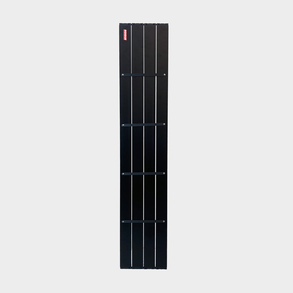 Close-up of the aluminium wheel arch shelf showing its matte black finish and slat construction